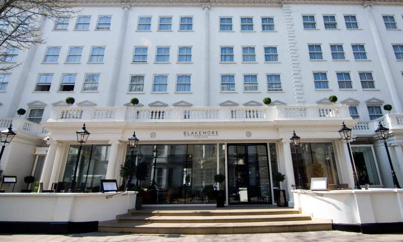 a large white building with a staircase in front of it at Blakemore Hyde Park in London