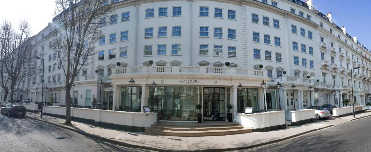 a large white building on the side of a street at Blakemore Hyde Park in London
